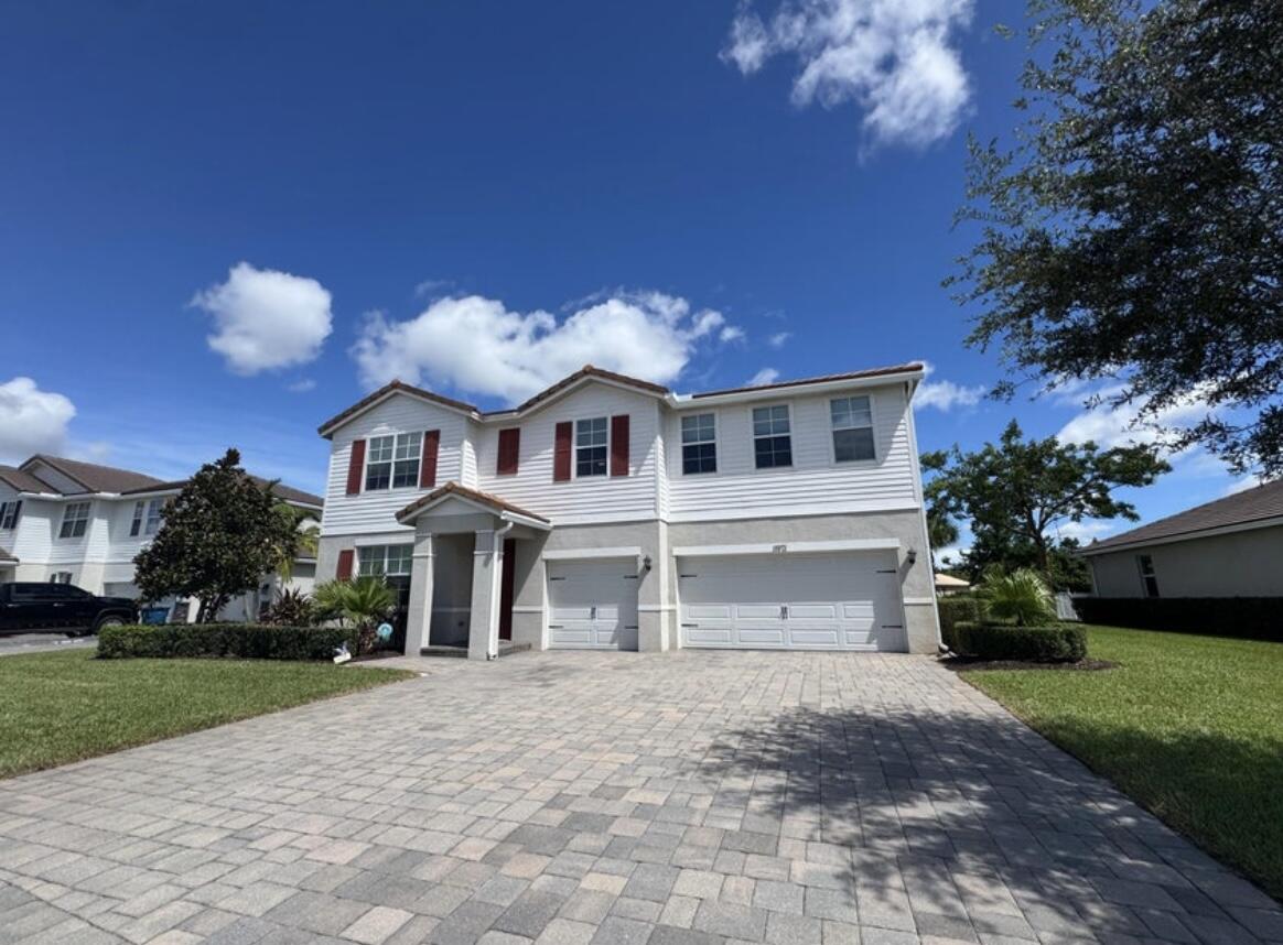 11971 Cypress Key Way Royal Palm Beach, FL 33411 - Photo 1 of 19 a front view of a house with a garden and plants