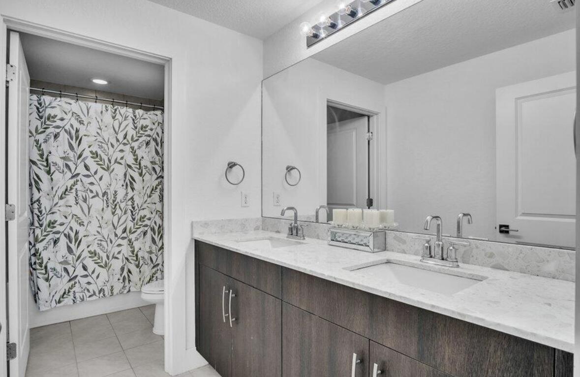 11971 Cypress Key Way Royal Palm Beach, FL 33411 - Photo 11 of 19 a bathroom with a double vanity sink and a mirror