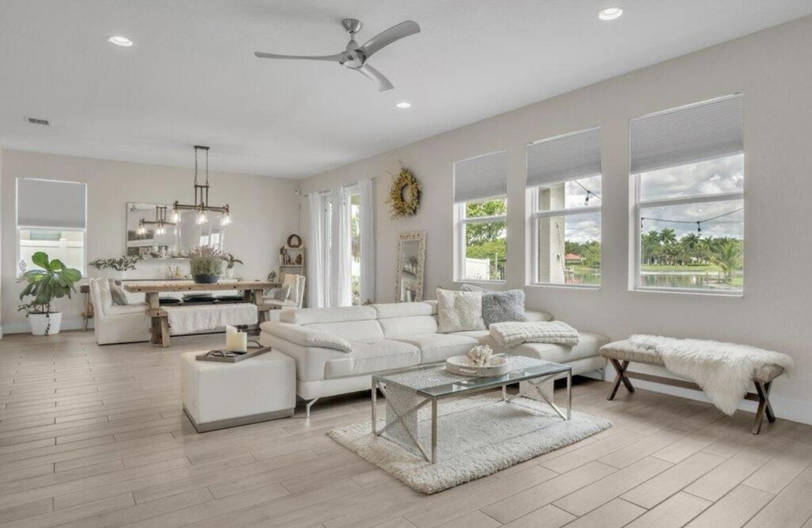 11971 Cypress Key Way Royal Palm Beach, FL 33411 - Photo 4 of 19 a living room with furniture and a large window