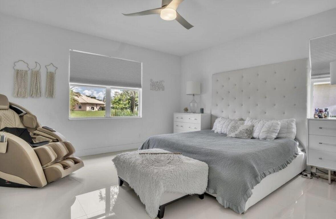 11971 Cypress Key Way Royal Palm Beach, FL 33411 - Photo 8 of 19 a bedroom with a bed and a couch