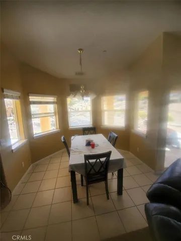 a bedroom with a bed tv and a desk