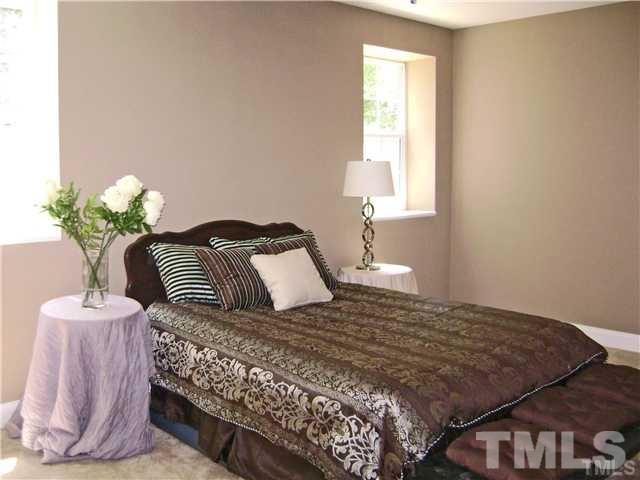 217 Camden Street Raleigh, NC 27601 - Photo 11 of 14 a bedroom with a bed and a window