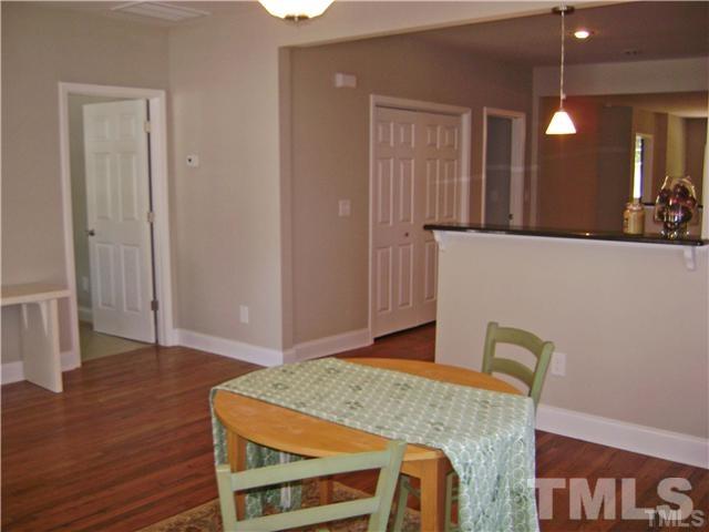 217 Camden Street Raleigh, NC 27601 - Photo 4 of 14 a view of a dining room with furniture and wooden floor