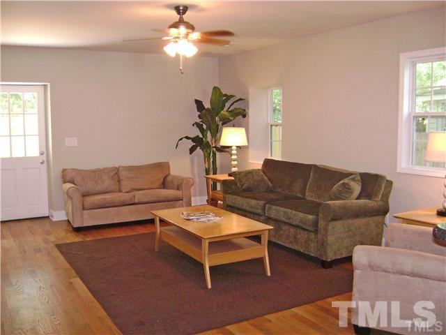 217 Camden Street Raleigh, NC 27601 - Photo 6 of 14 a living room with furniture a chandelier and a window