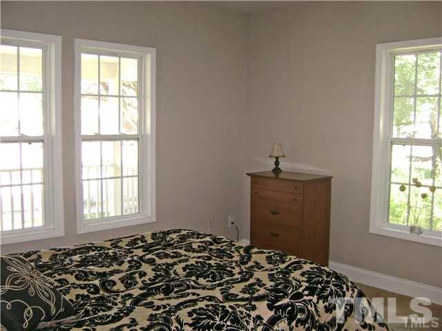 217 Camden Street Raleigh, NC 27601 - Photo 8 of 14 a bedroom with a bed and a window