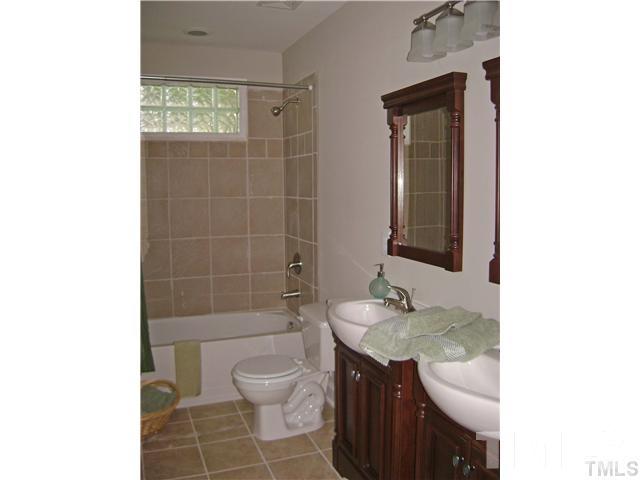 217 Camden Street Raleigh, NC 27601 - Photo 9 of 14 a bathroom with a granite countertop sink a toilet and shower