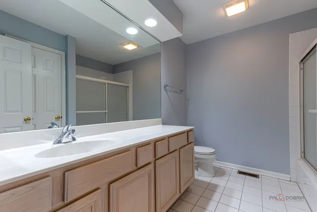 a bathroom with a sink toilet and a mirror