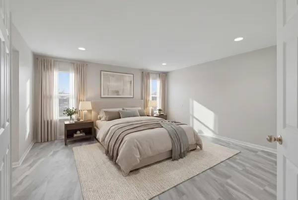 a spacious bedroom with a bed and a large window
