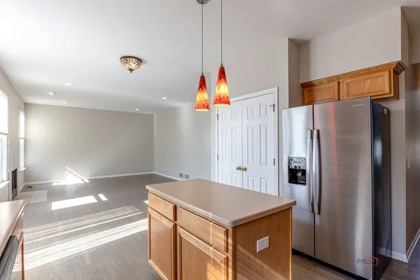 a kitchen with stainless steel appliances a refrigerator and a refrigerator