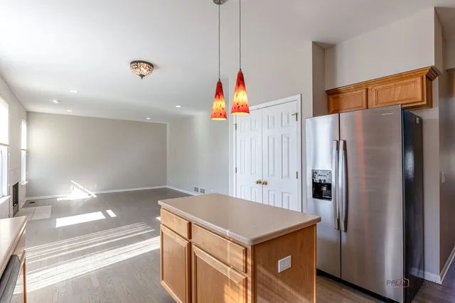 a kitchen with stainless steel appliances a refrigerator and a refrigerator