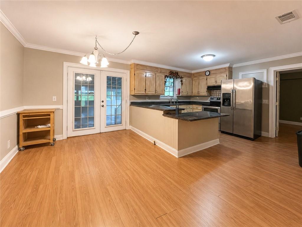 212 Craigtown Road Northeast Calhoun, GA 30701 - Photo 5 of 21 a kitchen with granite countertop a refrigerator and a stove top oven