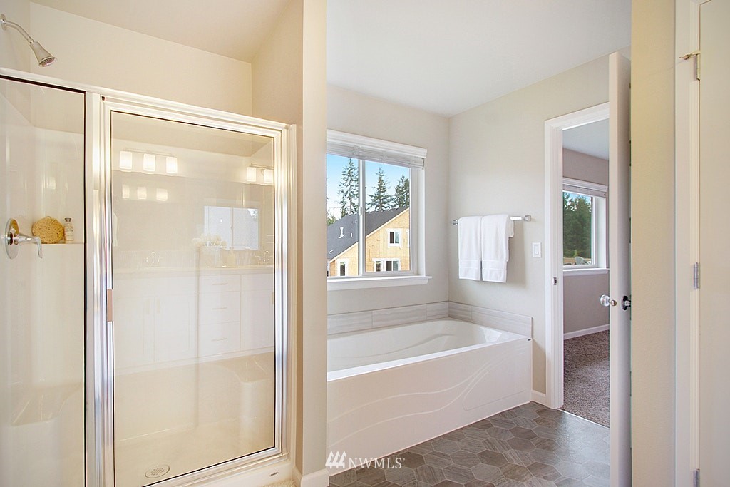 5202 Northeast 24th Street Renton, WA 98059 - Photo 15 of 22 a bathroom with a bathtub and a shower