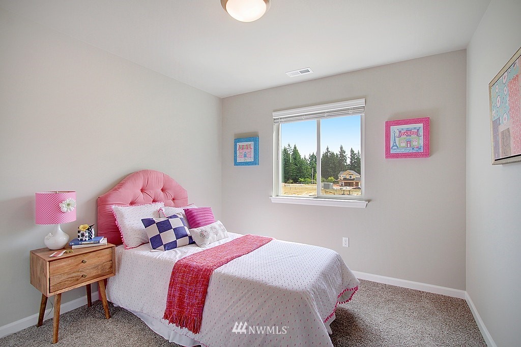 5202 Northeast 24th Street Renton, WA 98059 - Photo 16 of 22 a bedroom with a bed and a window
