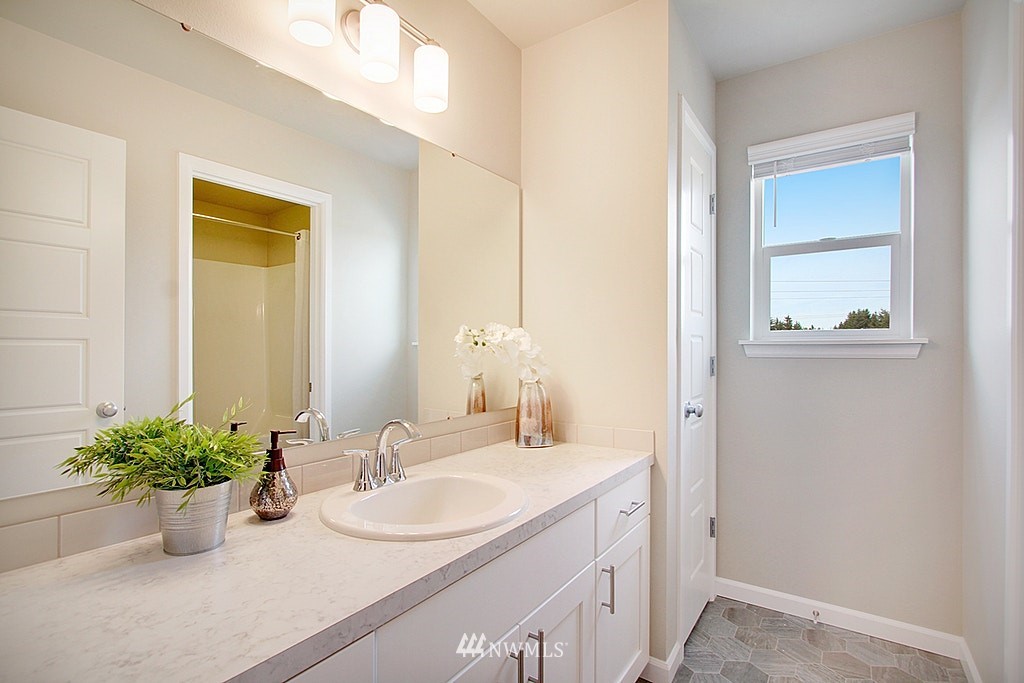5202 Northeast 24th Street Renton, WA 98059 - Photo 17 of 22 a bathroom with a potted plant and a sink