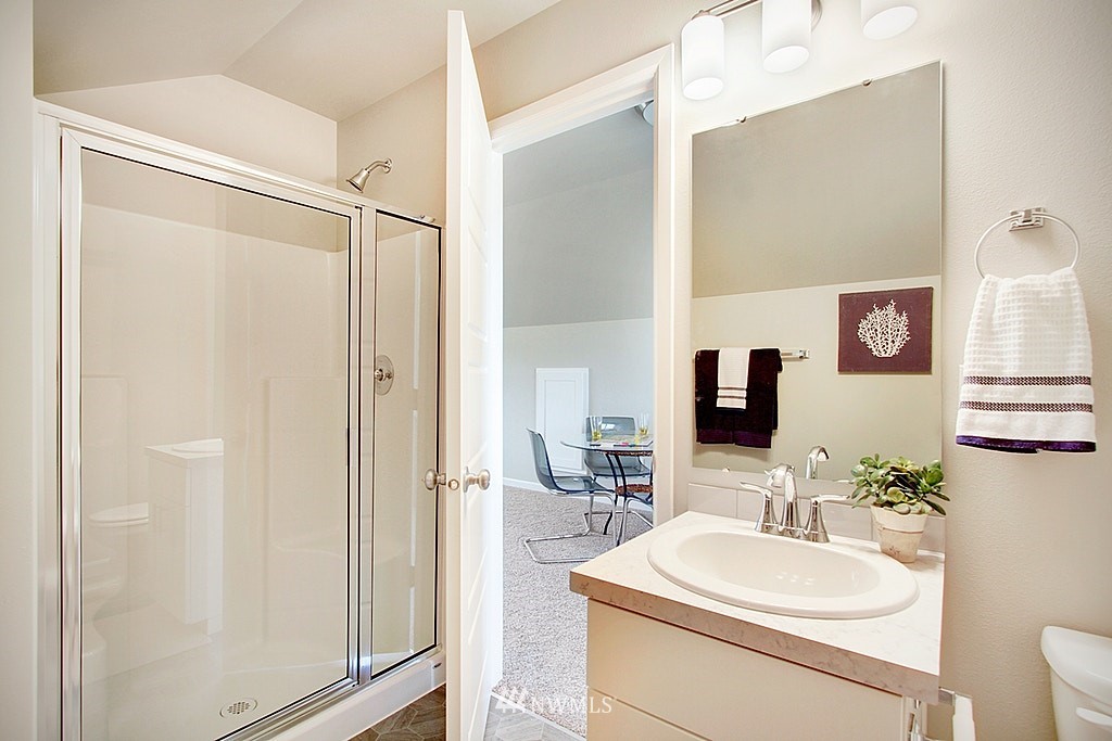 5202 Northeast 24th Street Renton, WA 98059 - Photo 19 of 22 a bathroom with a sink toilet a mirror and shower