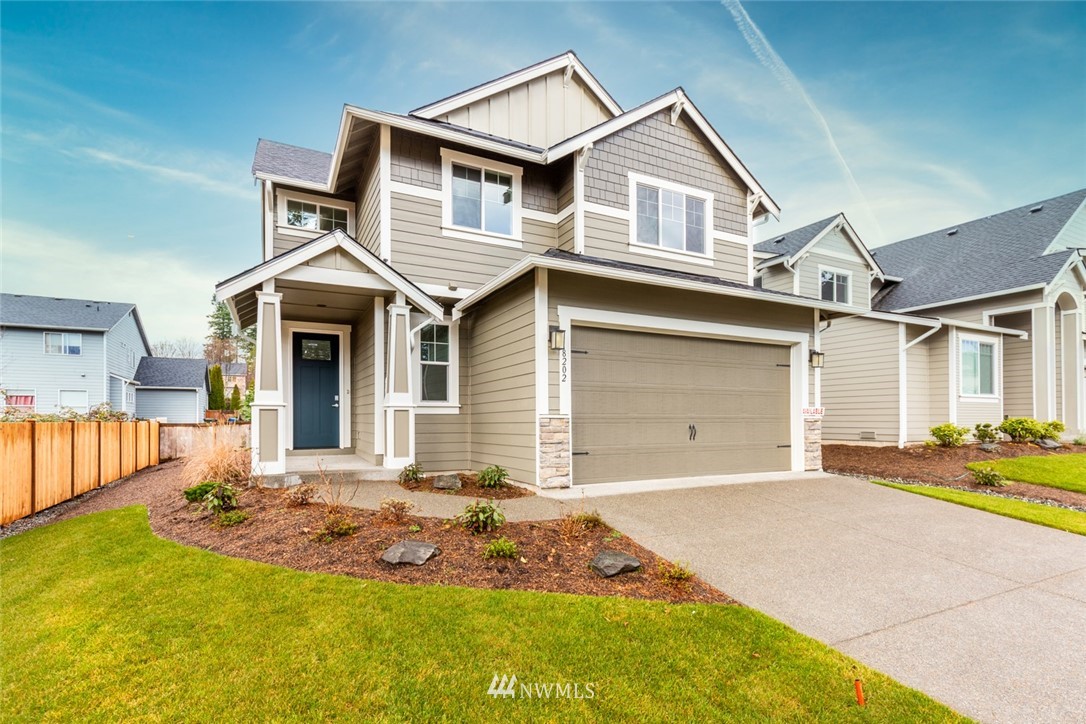 5202 Northeast 24th Street Renton, WA 98059 - Photo 22 of 22 a front view of a house with a yard and garage