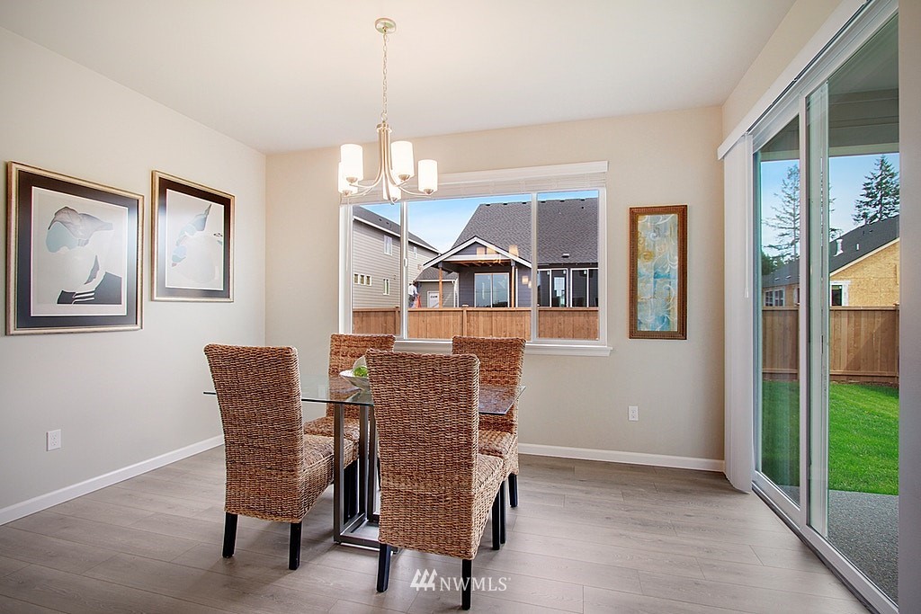 5202 Northeast 24th Street Renton, WA 98059 - Photo 8 of 22 a dining room with furniture a chandelier and wooden floor