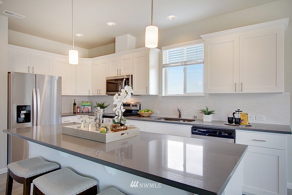 5202 Northeast 24th Street Renton, WA 98059 - Photo 9 of 22 a kitchen with white cabinets and refrigerator