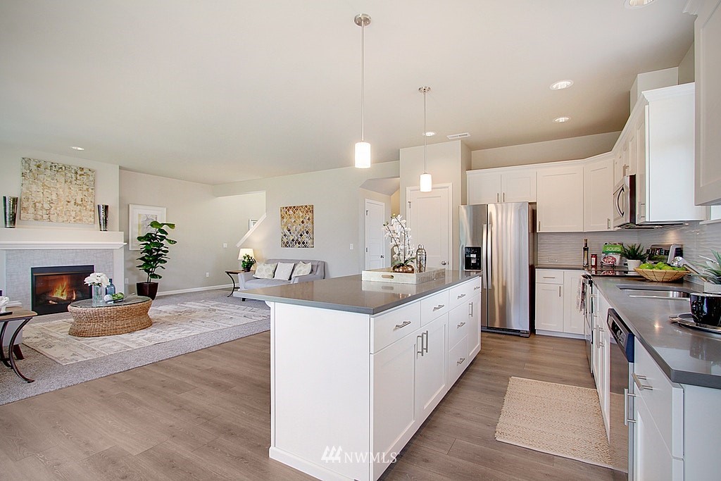 5202 Northeast 24th Street Renton, WA 98059 - Photo 10 of 22 a large kitchen with sink a refrigerator and a stove top oven