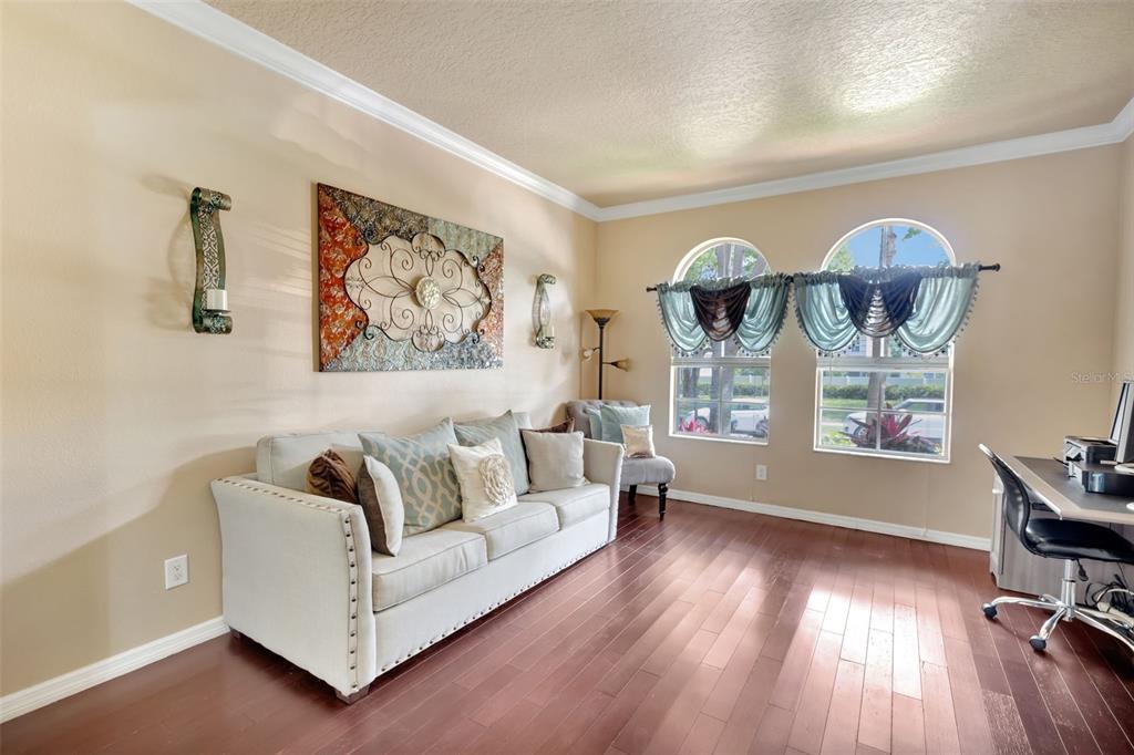 6932 Gray Catbird Loop Wesley Chapel, FL 33545 - Photo 20 of 25 a living room with furniture and wooden floor