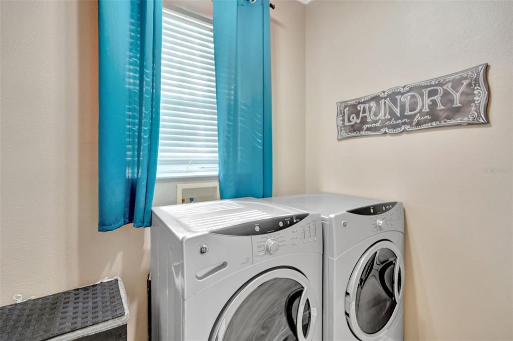 6932 Gray Catbird Loop Wesley Chapel, FL 33545 - Photo 21 of 25 a utility room with dryer and washer