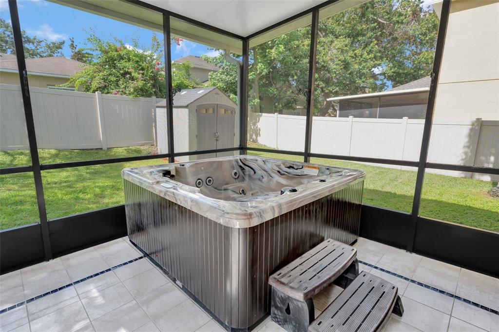 6932 Gray Catbird Loop Wesley Chapel, FL 33545 - Photo 22 of 25 a view of outdoor kitchen from a window