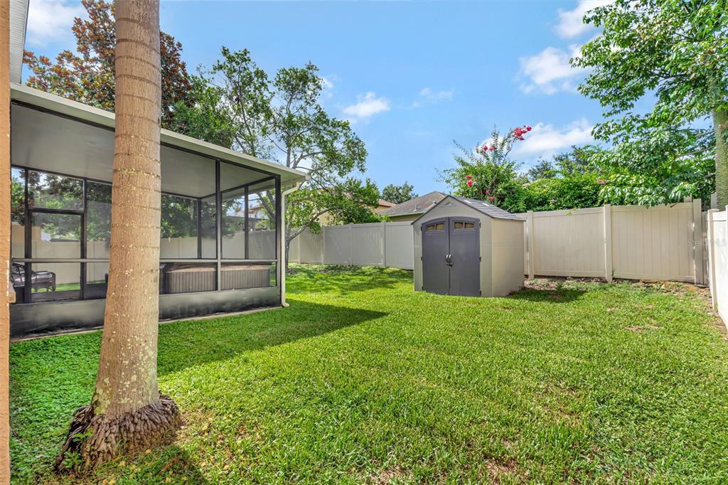 6932 Gray Catbird Loop Wesley Chapel, FL 33545 - Photo 25 of 25 a view of a house with backyard and a garden