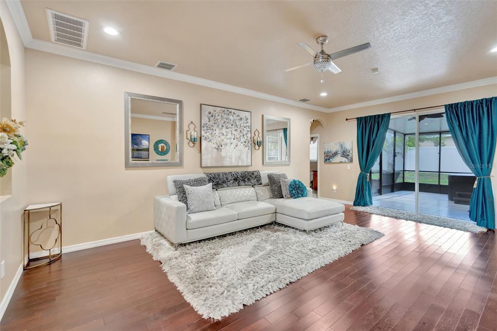 6932 Gray Catbird Loop Wesley Chapel, FL 33545 - Photo 3 of 25 a living room with furniture and a large window