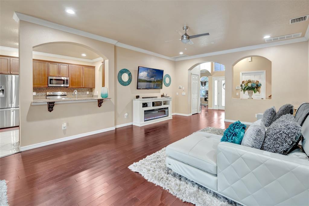 6932 Gray Catbird Loop Wesley Chapel, FL 33545 - Photo 4 of 25 a living room with furniture and a wooden floor