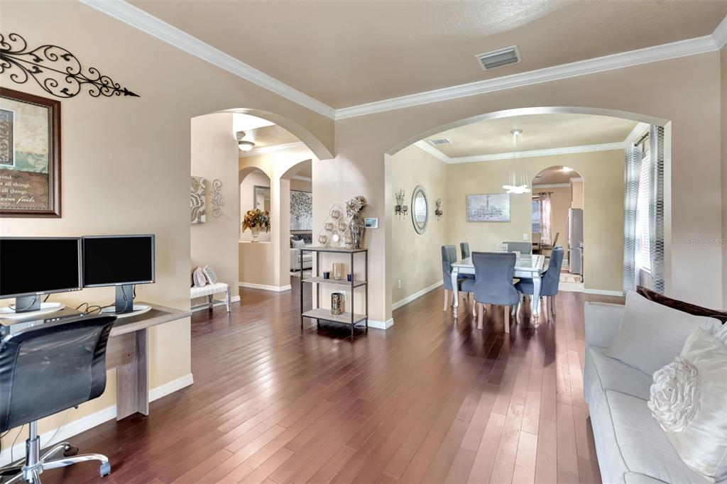 6932 Gray Catbird Loop Wesley Chapel, FL 33545 - Photo 5 of 25 a workspace with furniture and wooden floor