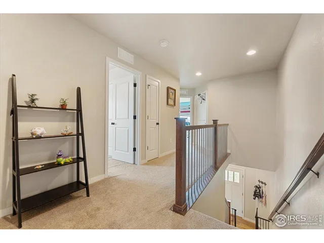 a kitchen with a refrigerator a stove top oven with white cabinets