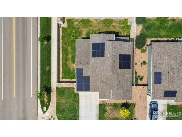 a view of an empty room with wooden floor and closet