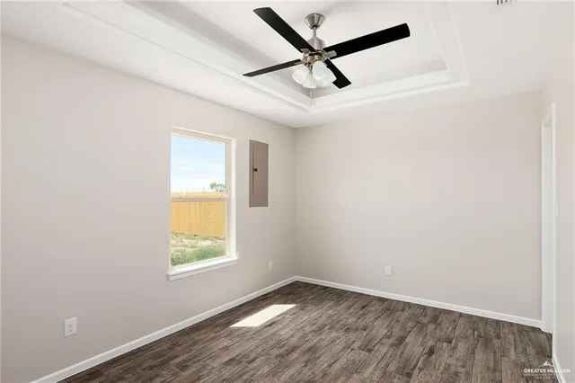 an empty room with a window and a ceiling fan