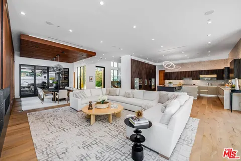 a living room with lots of furniture and a wooden floor