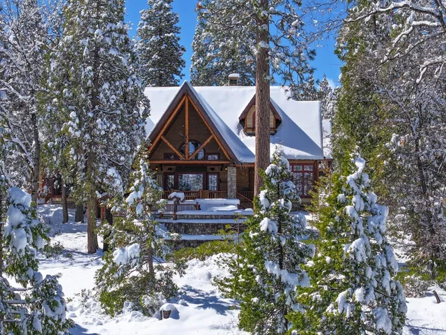 a front view of a house with a yard and fountain