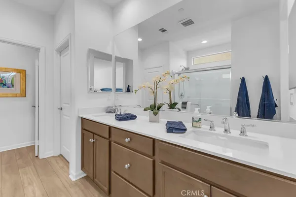 a bathroom with a double vanity sink and a mirror