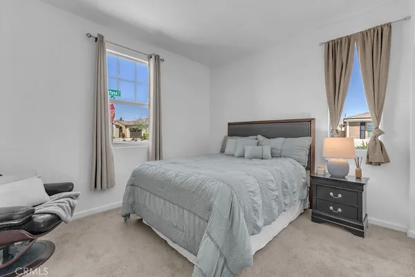 a bedroom with a bed and a couch