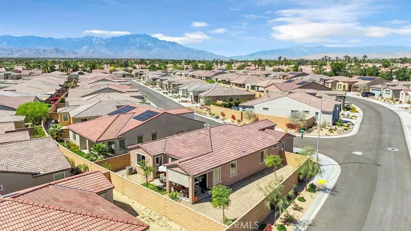 an aerial view of a house with a yard
