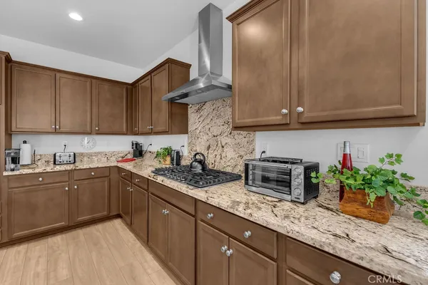 a kitchen with granite countertop cabinets and potted plant