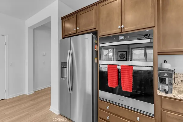 a kitchen with stainless steel appliances granite countertop a refrigerator and a stove top oven