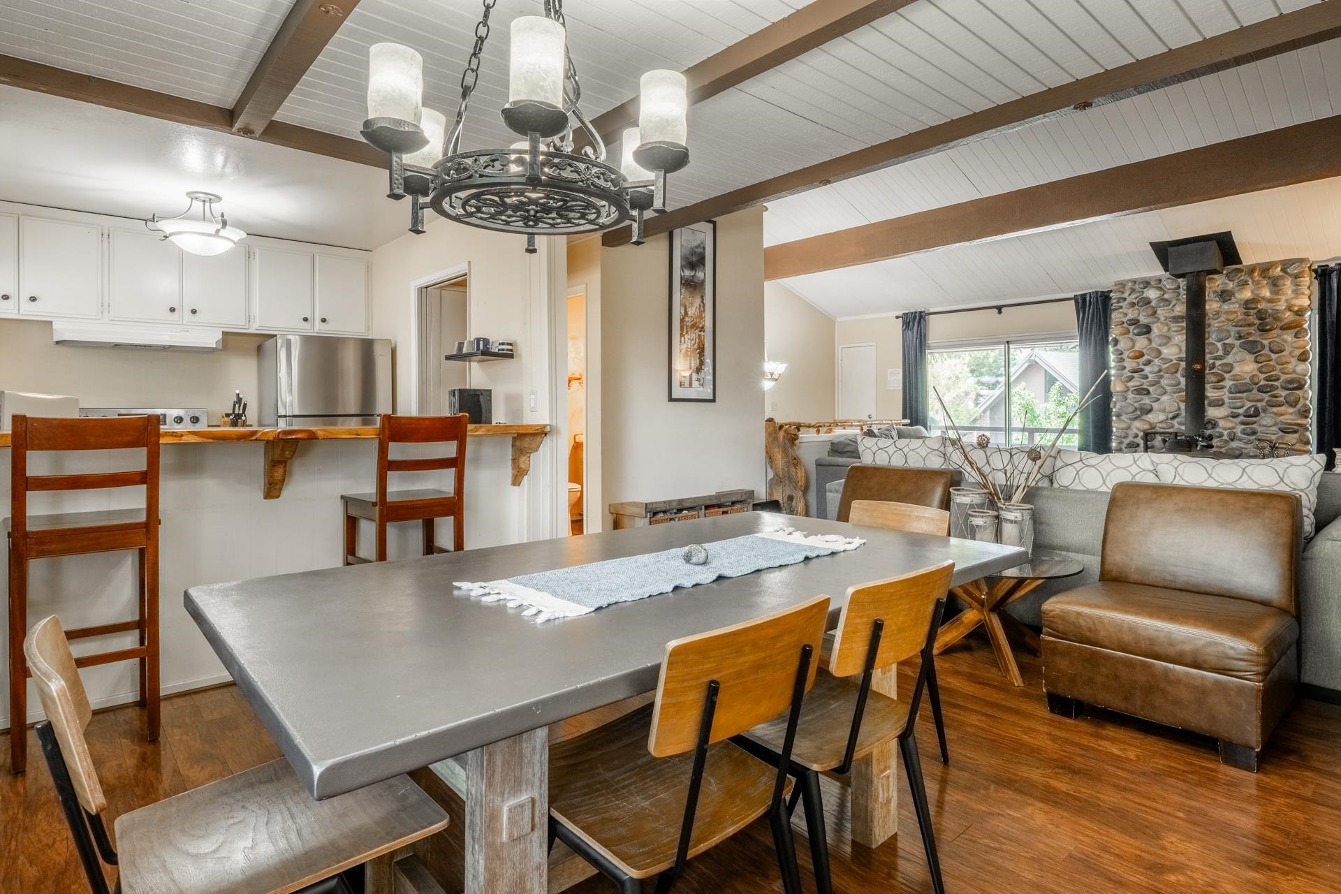 165 Old Mammoth Road, Unit 3 Mammoth Lakes, CA 93546 - Photo 9 of 48 Dining area featuring a rustic chandelier and wood-finish flooring