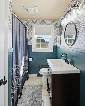 a bathroom with a sink a toilet and a mirror