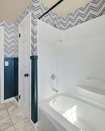 a bathroom with a bathtub and shower
