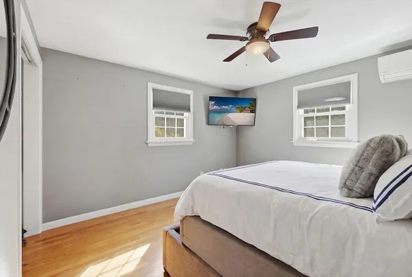 a bedroom with a bed dresser and a window