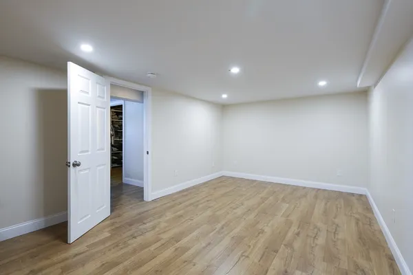 a view of empty room with wooden floor