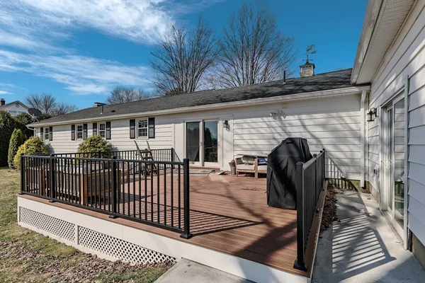 a view of a roof deck with couches and wooden floor