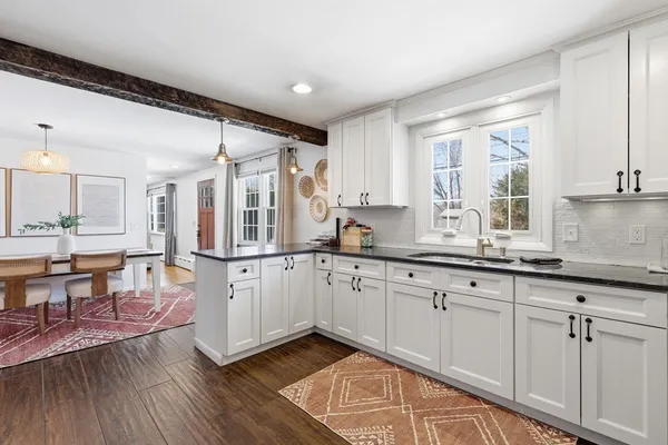 a kitchen with sink cabinets and wooden floor
