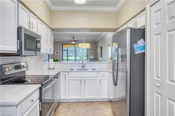 a kitchen with stainless steel appliances a sink stove and cabinets