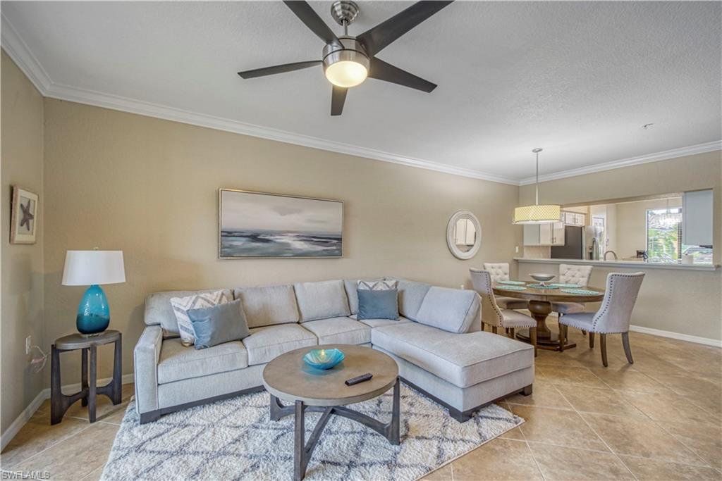 9560 Trevi Court, Unit 4815 Naples, FL 34113 - Photo 12 of 38 a living room with furniture and a lamp