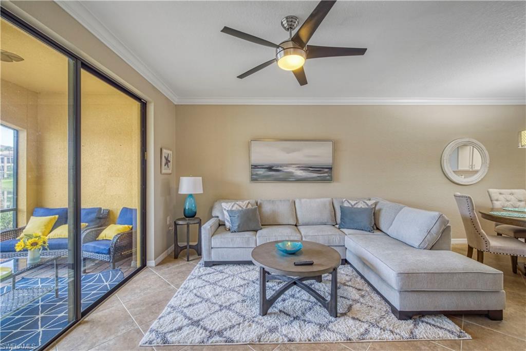 9560 Trevi Court, Unit 4815 Naples, FL 34113 - Photo 13 of 38 a living room with furniture and a large window